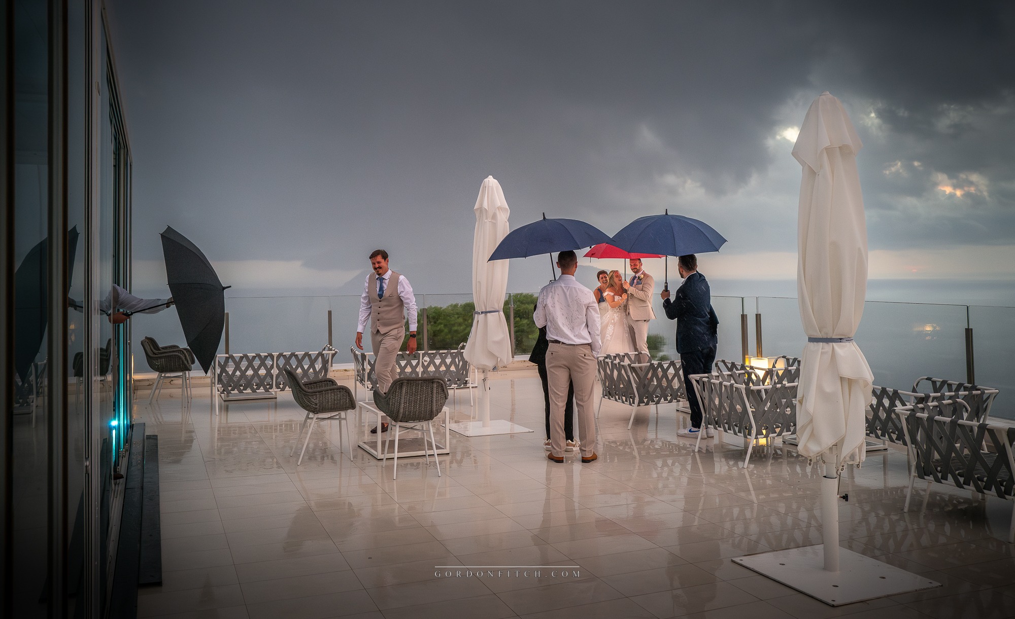 Bride and Groom Downpour - Raleis Blu - Italy by Gordon Fitch