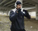 A man doing audio only traditional Taekwondo training outdoors