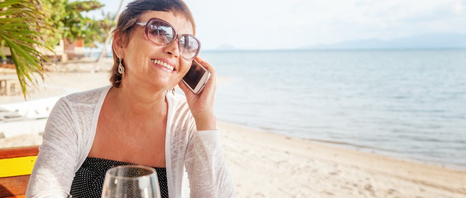 happy woman on phone on beach