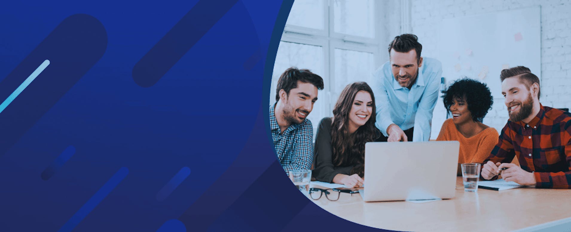 Three men and Two Women at Business Meeting And Seated at Tan Table With Silver Laptop