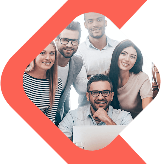 People Standing Behind a Man Sitting in Front of a Laptop Computer