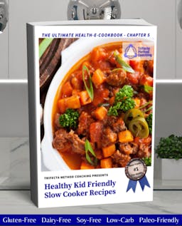 A white crockpot is filled with vegetables, including carrots, greens, hamburger, a red sauce and garnished with a couple sliced jalapenos. It reads "Trifecta Method Coaching Presents: Healthy Kid Friendly Slow Cooker Recipes". With a "Best Foods #1 For Health" ribbon.