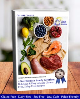 An array of raw, whole foods - broccoli, lemon, blueberries, almonds, pomegranate, ginger, avocado, raw salmon, raw beef, raw chicken