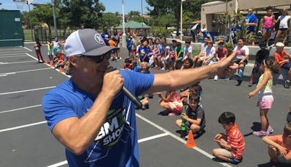 Dave announcing at a school assembly