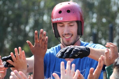 Mitch High 5's at school assembly
