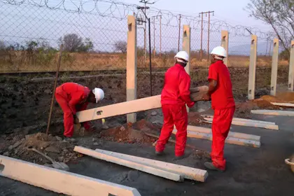 Classy Creations team installing a concrete palisade post for a security fencing project in Limpopo