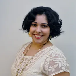 Headshot of woman in white shirt and red lipstick