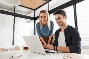 Self Employed man and woman looking at a laptop