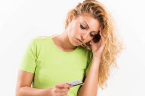 Women looking at a credit card with Adverse Credit