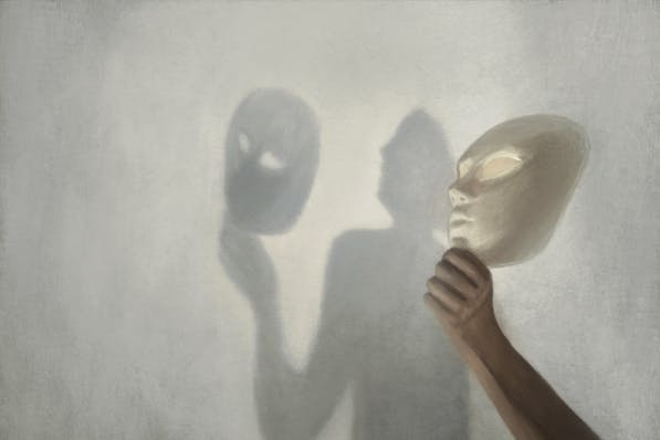 A shadowy figure holding two theatrical masks, one in each hand, against a soft-focused, illuminated backdrop, creating a mysterious and dramatic effect.