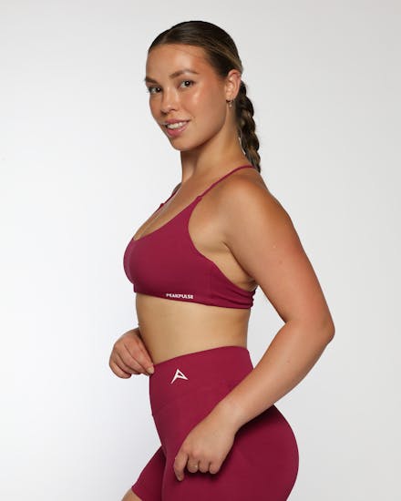 On-model photo of a red sleeveless activewear top suitable for yoga and training