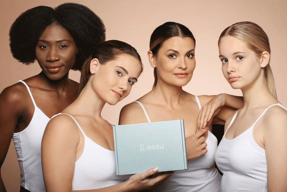 Man reading a book with a cup of coffee in his other hand, sitting in West Village in West End, Brisbane