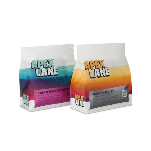 Two coffee packages placed side by side, photographed in a Brisbane studio to showcase branding and product details