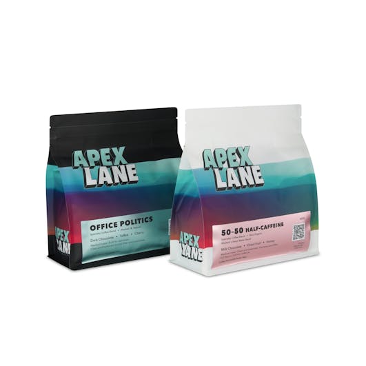 Two coffee packages placed side by side, photographed in a Brisbane studio to showcase branding and product details