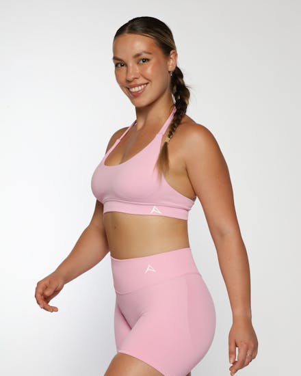 Athletic model showcasing a purple strappy back activewear top styled by VERAS Studio