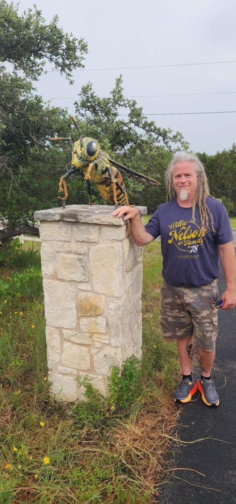 art exhibit subject next to sculptor