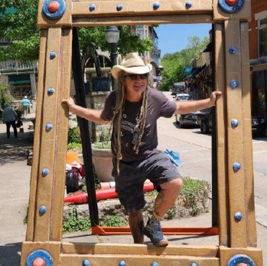 artist in giant frame