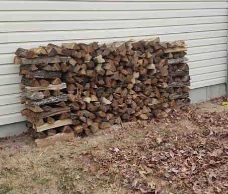 firewood stacked by house